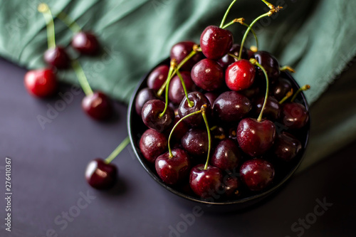 cherries in black containers on the table