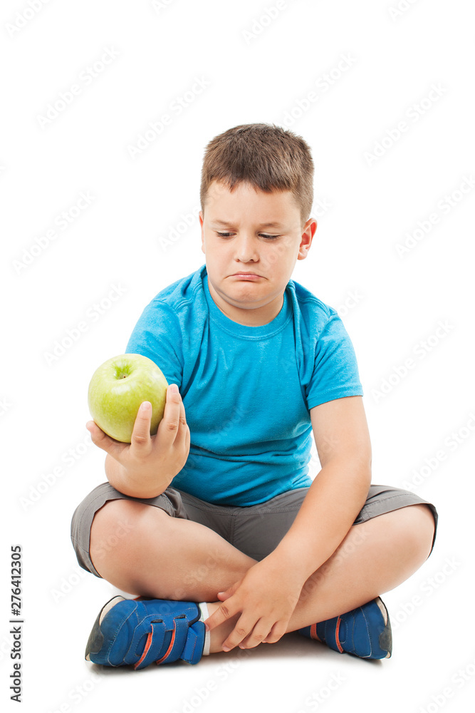 Fototapeta premium Fat boy and apple, sitting on floor. Isolated on white background