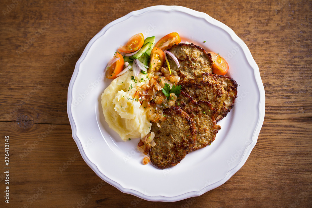 Chicken liver pancakes with mashed potato and vegetables on white plate. Liver side dish Chicken liver pancakes with mashed potato and vegetables on white plate. Liver side dish