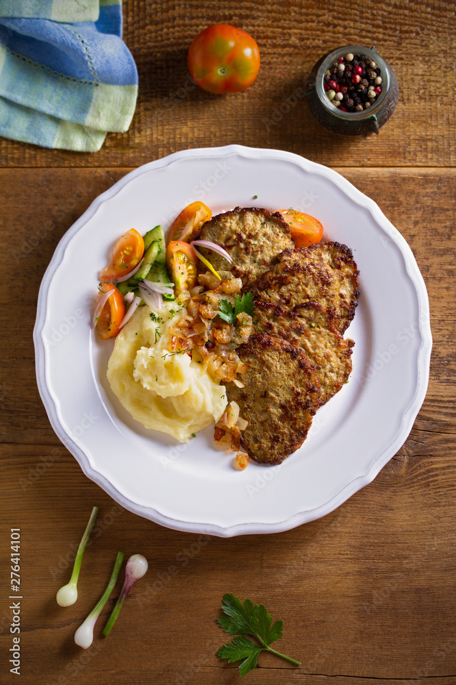Chicken liver pancakes with mashed potato and vegetables on white plate. Liver side dish Chicken liver pancakes with mashed potato and vegetables on white plate. Liver side dish