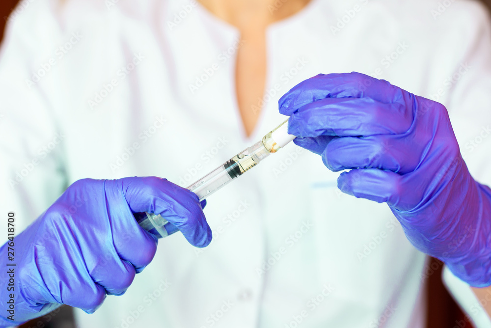 Woman hands holding syringe ampoule Woman hands holding syringe ampoule