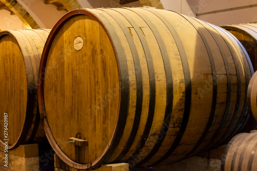 Vintage wine cellar with old oak barrels, production of fortified dry or sweet marsala wine in Marsala, Sicily, Italy