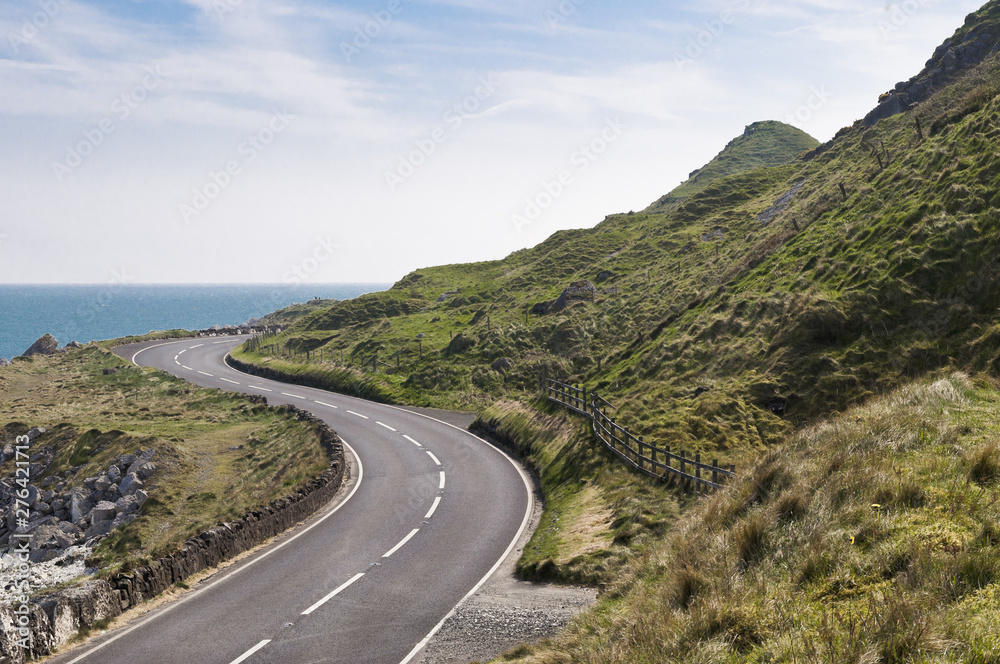 Road by the sea on Causeway coastal route in county antrim, Northern Ireland