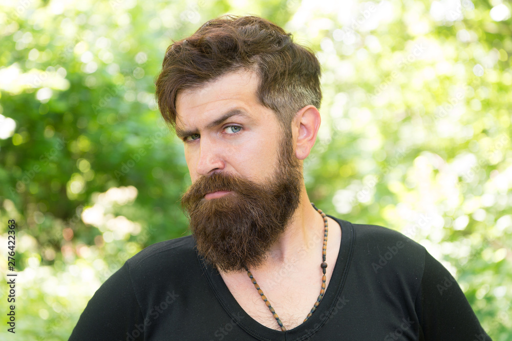 This is what man wants to look like. Bearded man in casual style on natural landscape. Caucasian man with long mustache and beard hair outdoor. Brutal man with unshaven face and stylish haircut This is what man wants to look like. Bearded man in casual style on natural landscape. Caucasian man with long mustache and beard hair outdoor. Brutal man with unshaven face and stylish haircut