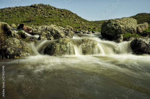 Waterfalls on a mountain stream. A delightful spring landscape. Mount Aragats. Armenia