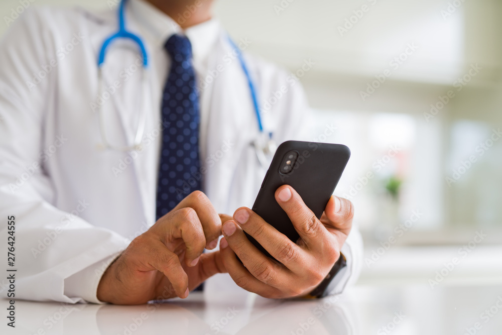 Close up middle age doctor man hands using smartphone Close up middle age doctor man hands using smartphone