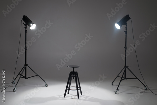 Ready photo shoot setup in white background in the studio. Photography Studio with Empty Chair