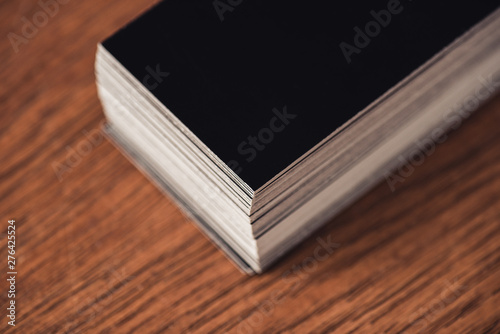 stack of black empty business cards on brown wooden tabletop