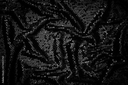 Metal glitter black cloth background, close up. Trendy Metallic