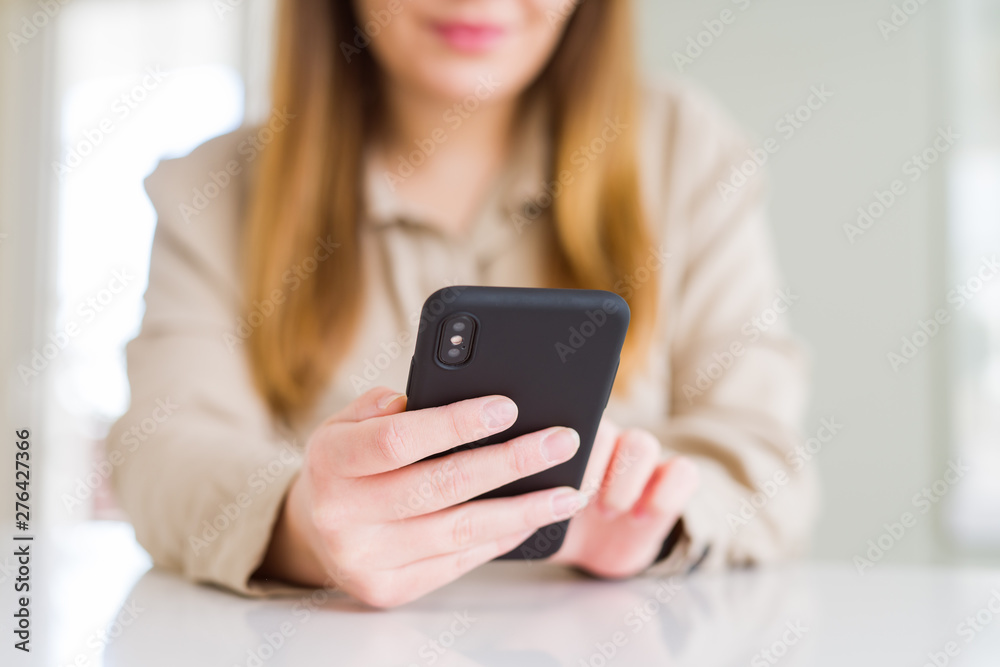 Close up of woman using smartphone and smiling confident Close up of woman using smartphone and smiling confident