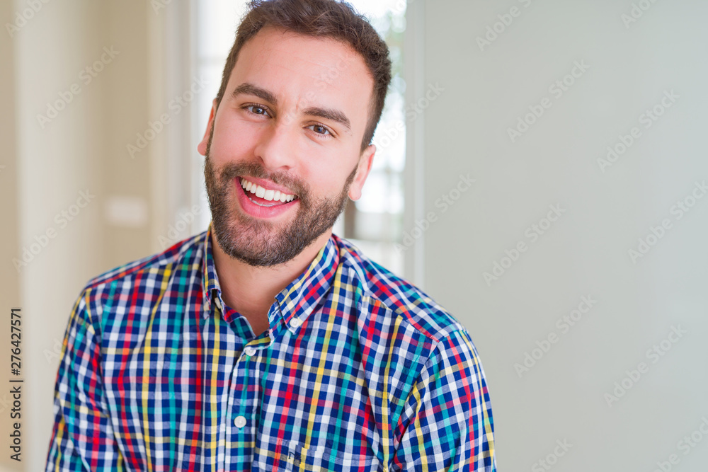 Handsome man wearing colorful shirt and smiling positive at the camera Handsome man wearing colorful shirt and smiling positive at the camera