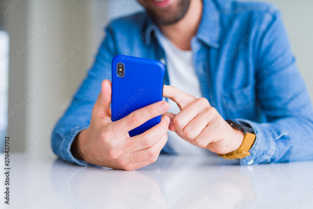 Close up of man hands using smartphone and smiling Close up of man hands using smartphone and smiling