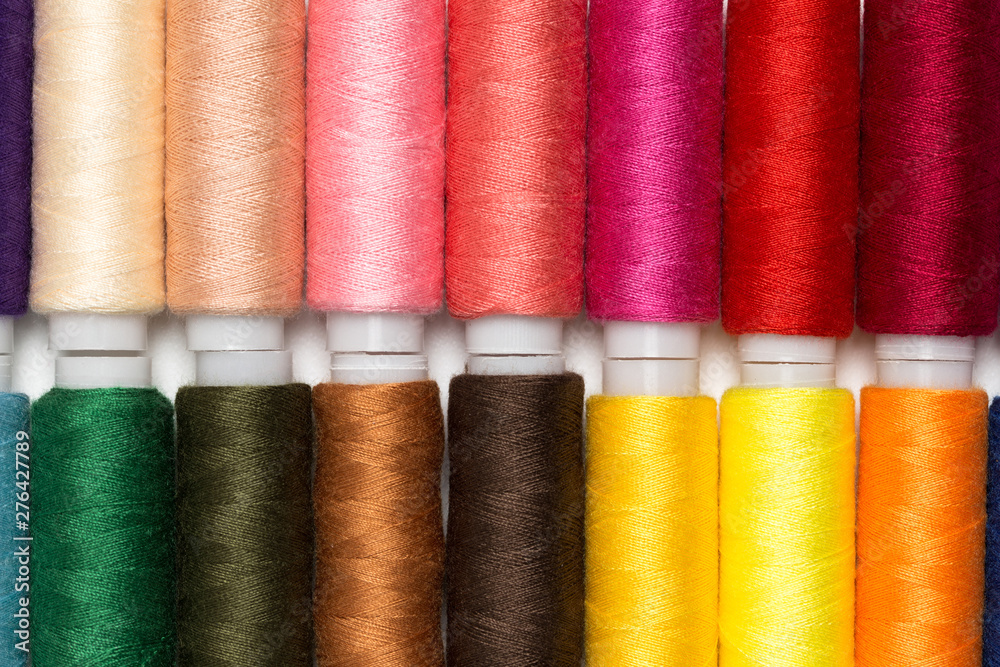 Close up colourful spools of thread. Macro photography fashion tailor background Close up colourful spools of thread. Macro photography fashion tailor background