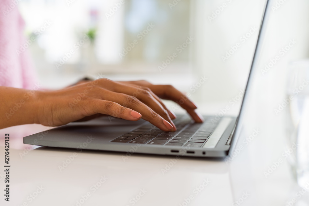 Close up of young woman working typing using laptop Close up of young woman working typing using laptop