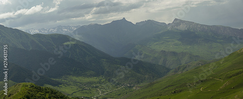 amazing view of mountain peaks  meadows and valleys. Panorama. High resolution. Toned.
