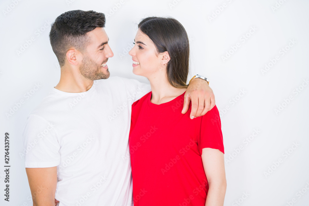 Young beautiful couple in love hugging over white isolated background Young beautiful couple in love hugging over white isolated background