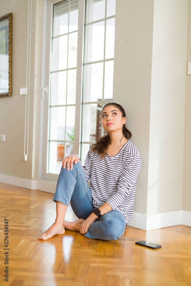 Beautiful arab woman sitting on the floor at home Beautiful arab woman sitting on the floor at home