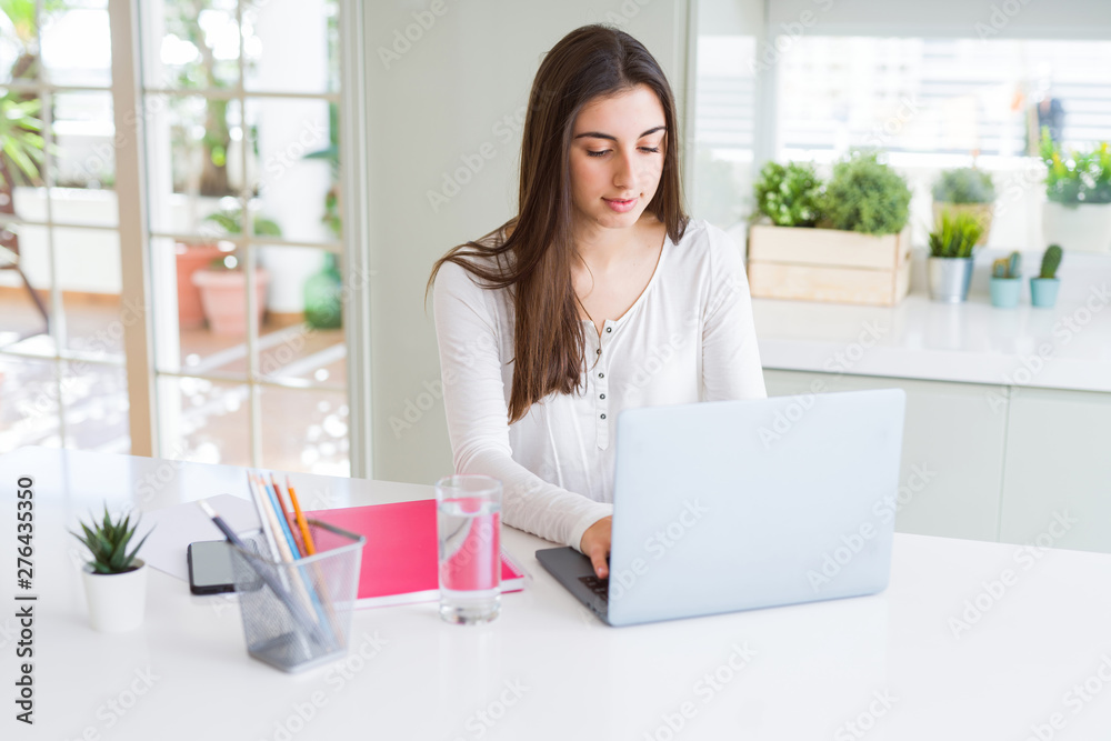 Young beautiful woman concentrated working using computer laptop Young beautiful woman concentrated working using computer laptop