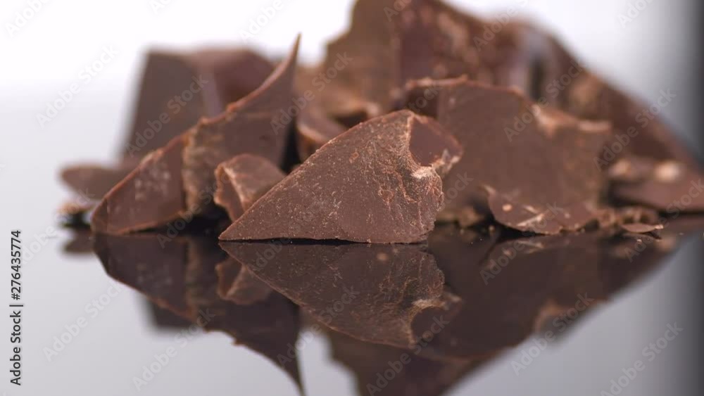 Chocolate. Chunks of sweet dark chocolate rotated closeup. Dessert ingredient. Confectionery. Rotation. Slow motion. 4K UHD video footage. 3840X2160 Chocolate. Chunks of sweet dark chocolate rotated closeup. Dessert ingredient. Confectionery. Rotation. Slow motion. 4K UHD video footage. 3840X2160