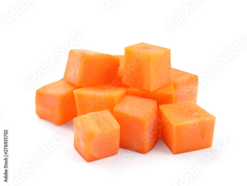Fresh ripe carrot cut in cubes on white background