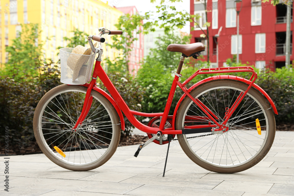Modern color bicycle with basket in park