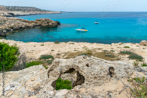 Hole in the stone on the shore of the blue lagoon.