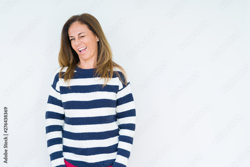 Beautiful middle age woman wearing navy sweater over isolated background winking looking at the camera with sexy expression, cheerful and happy face. Beautiful middle age woman wearing navy sweater over isolated background winking looking at the camera with sexy expression, cheerful and happy face.