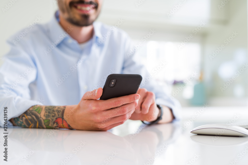 Close up of business man working using smartphone smiling confident