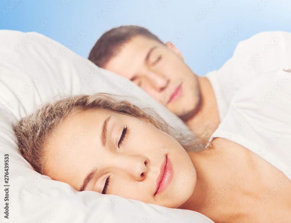 Young beautiful couple sleeping in white bed Young beautiful couple sleeping in white bed