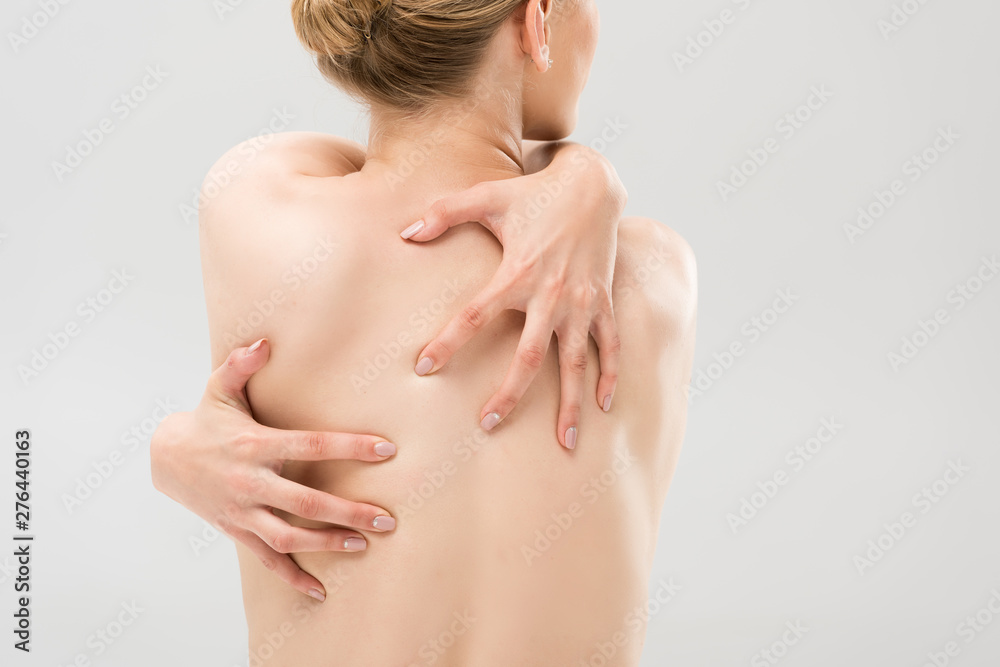 back view of sexy naked woman embracing herself isolated on grey back view of sexy naked woman embracing herself isolated on grey