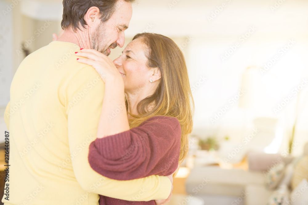 Romantic middle age couple dancing together in love at home Romantic middle age couple dancing together in love at home