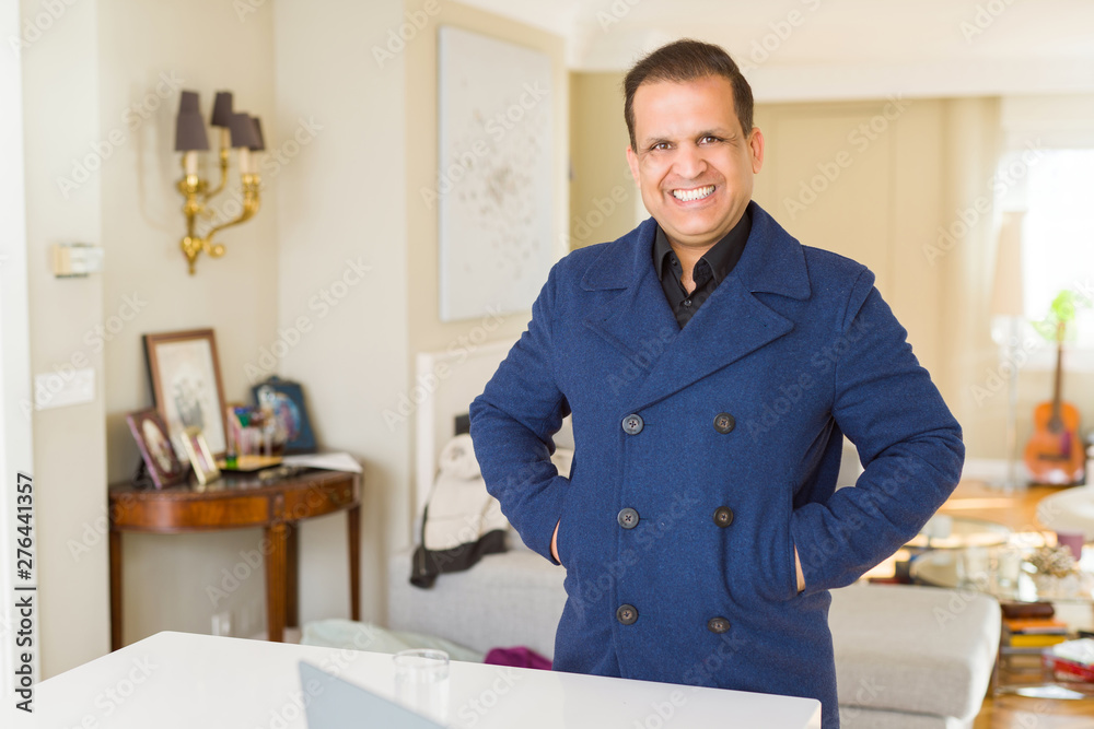 Middle age man smiling confident to the camera at home Middle age man smiling confident to the camera at home