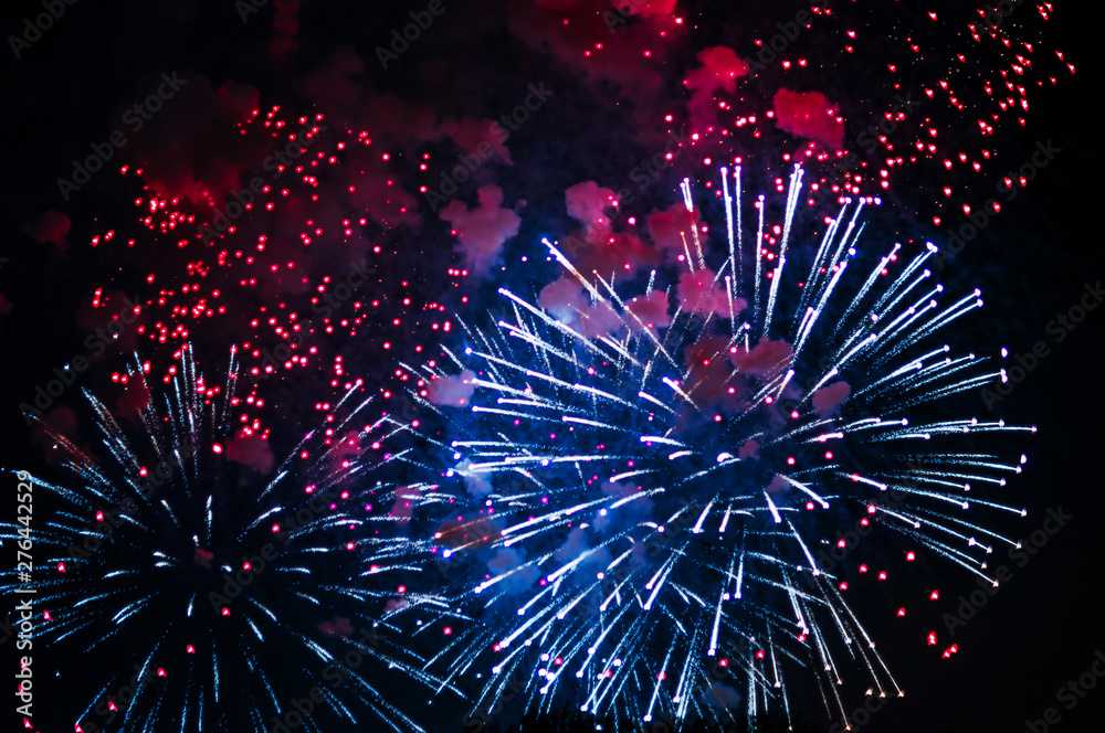 Inexpensive fireworks, over the city, white, red and blue . For any purpose.