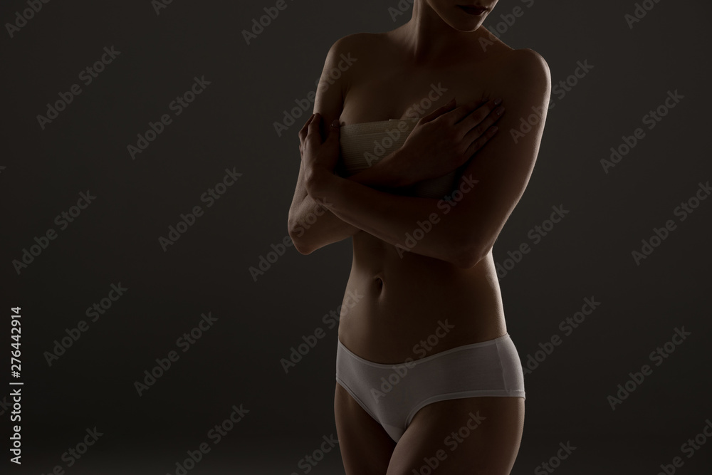cropped view of woman in panties with breast bandage in darkness - obrazy, fototapety, plakaty 