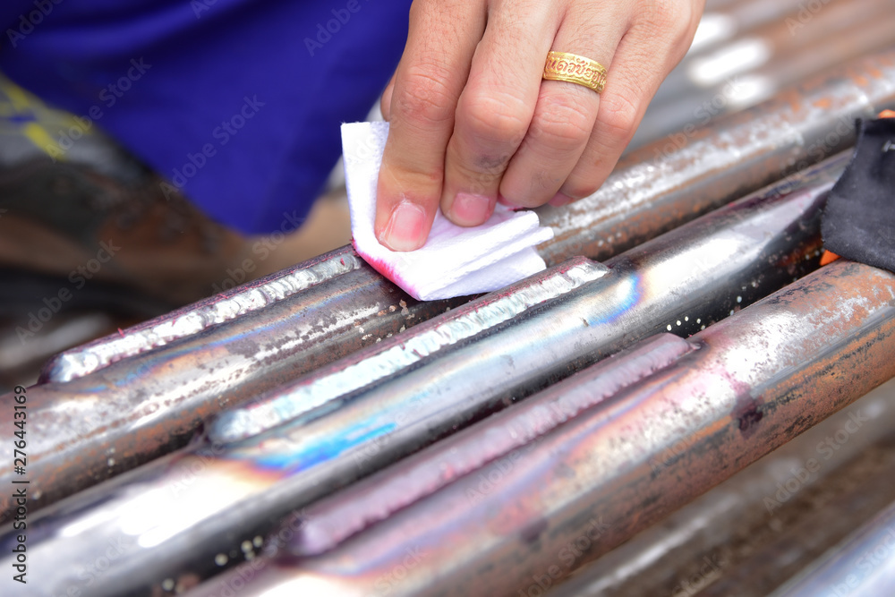 Fototapeta premium Workers are remove the penetrant from the workpiece.This is the second step of Penetrant Testing (PT).