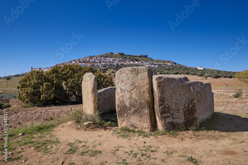 Dolmen of "cerca del marco", Ancient megalithic construction with the town of Magacela in the background. Extremadura. Spain