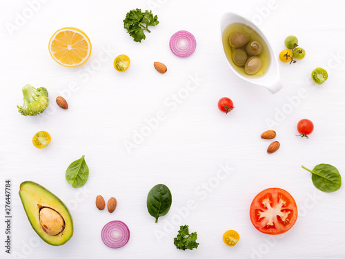 Food background and salad concept with raw ingredients flat lay on white wooden background.
