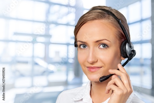 Close-up view of young woman face with headphones, call center or support concept