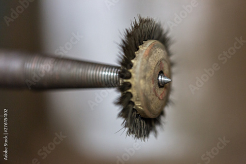 Close up of a mechanic polishing brush used by jewellers to cultivate and polish precious metals such as gold and silver for their jewellery photo