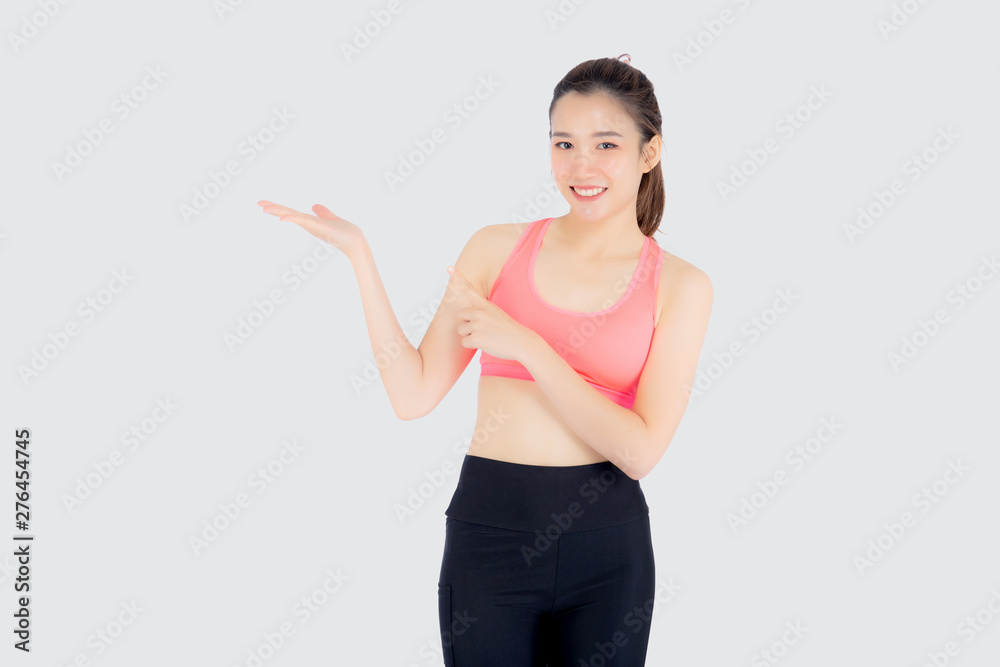 Beautiful portrait young asian woman in sport clothing with satisfied and confident presenting something empty on the hand isolated on white background, girl exercise for fit with health concept. Beautiful portrait young asian woman in sport clothing with satisfied and confident presenting something empty on the hand isolated on white background, girl exercise for fit with health concept.