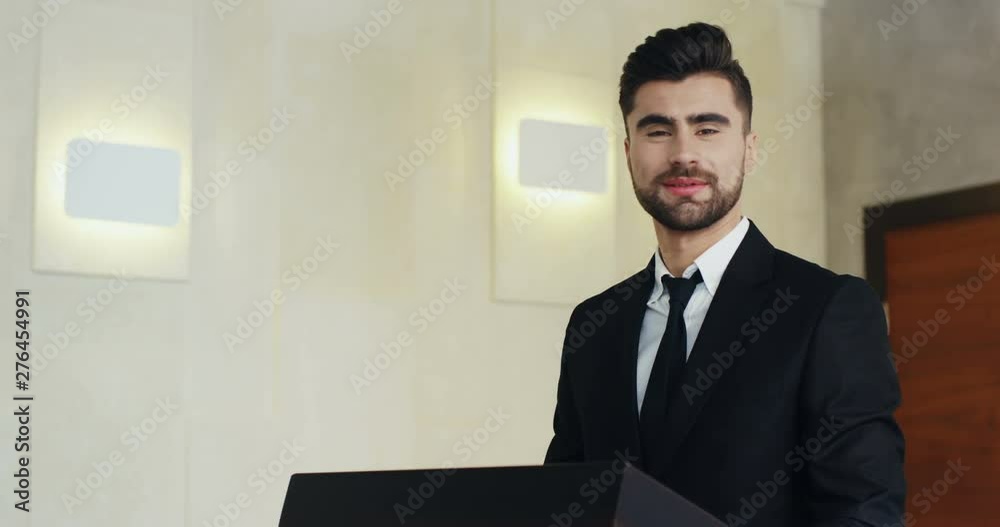 Portrat of the handsome young man in suit and tie standing at the ...