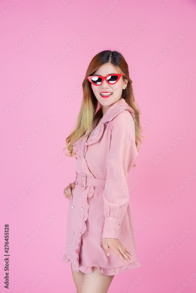 Fashion girl dress up with a hand gesture on a pink background. Fashion girl dress up with a hand gesture on a pink background.