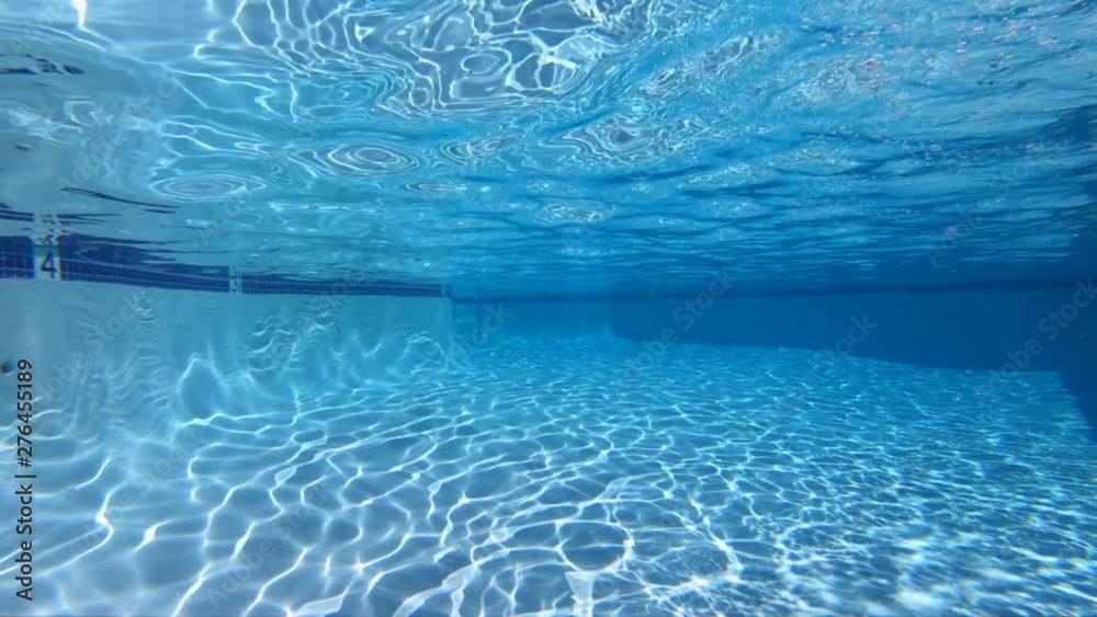 Slow motion view of underwater sunlight patterns in clean empty swimming pool.  Shot at 240 frames per second.  