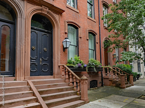 stone front step of elegant old urban brownstone type townhouse with double door