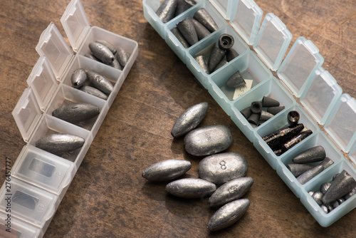 Canvas Print Lead weights or sinkers used for fishing, in variety of sizes, in a plastic separated compartment case