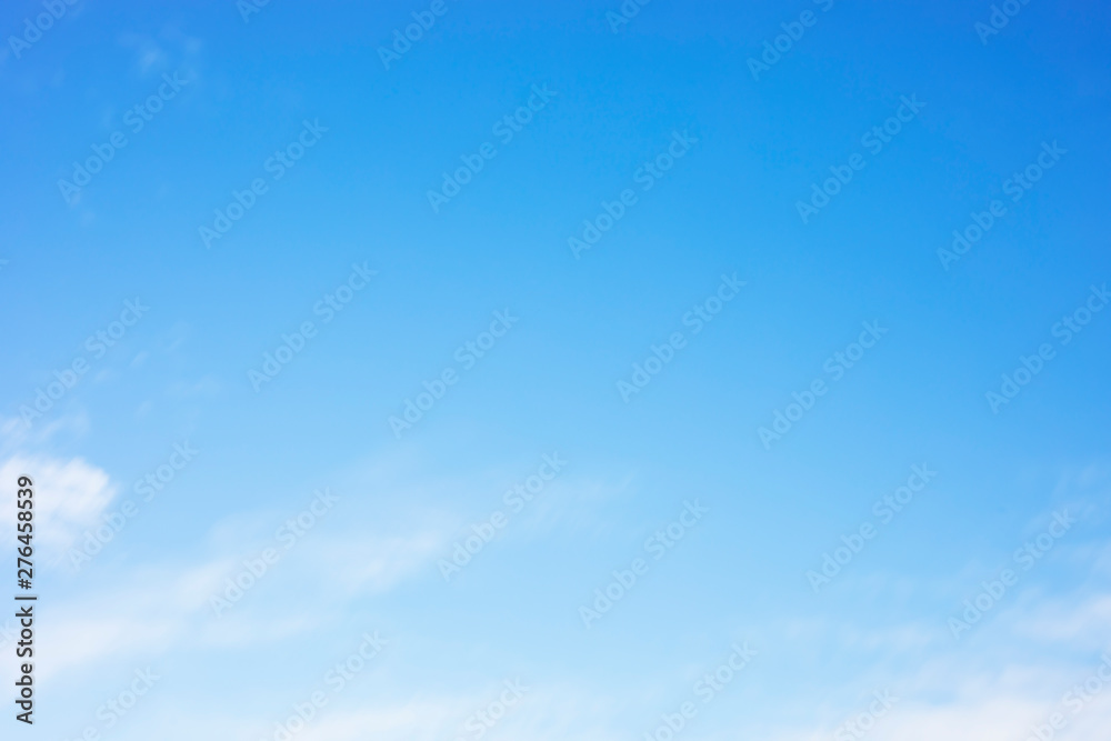 Blue sky background and white clouds soft focus, and copy space