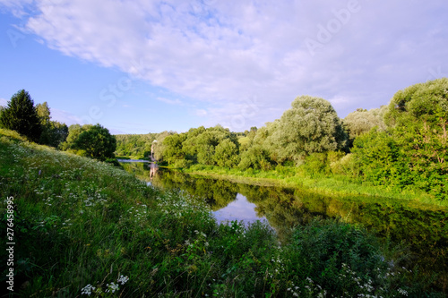 Summer river landscape. View of a small river and shore on a summer day.