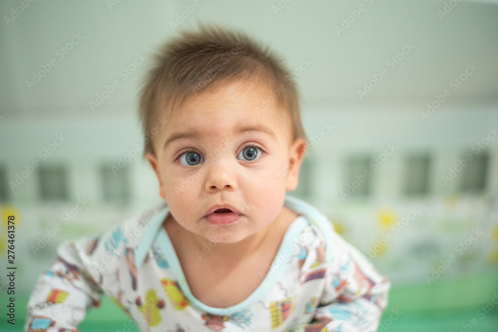 Blue-eyed baby in crib