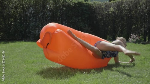 Funny summer fail video as a woman falls off of an inflatable couch in her backyard