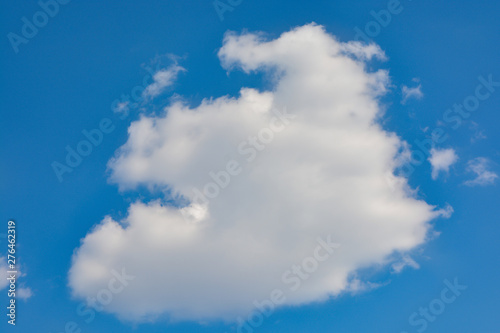 Fluffy white clouds on a blue sky background